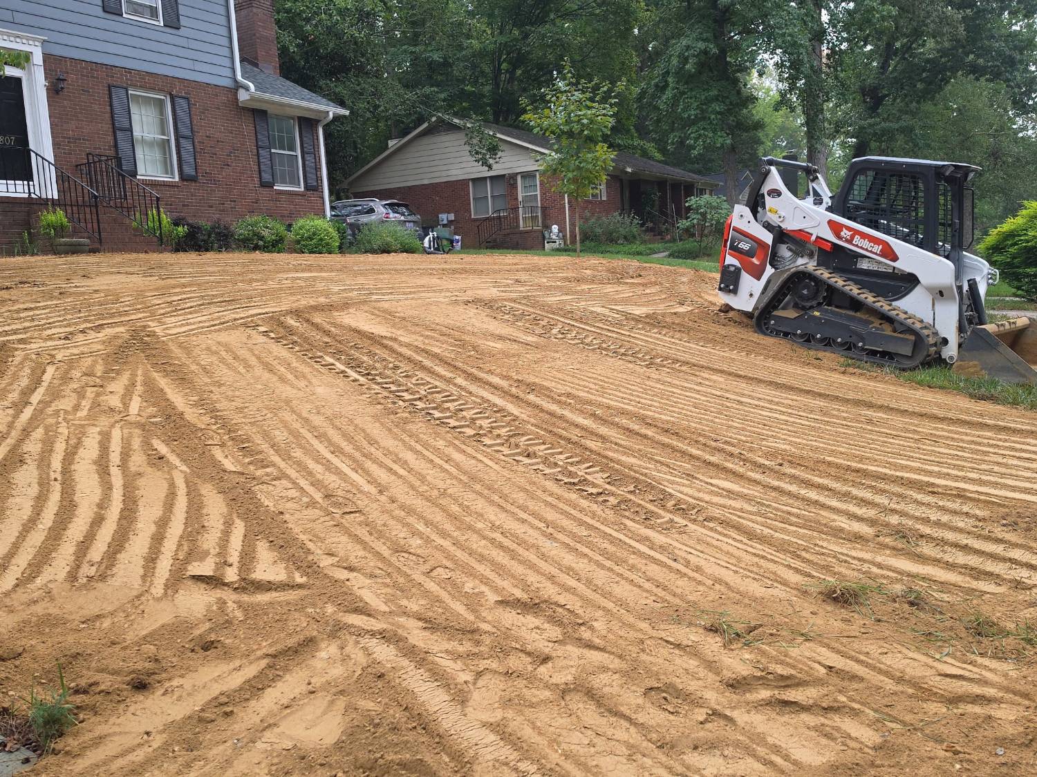 Front yard regraded for proper drainage with a Bobcat track loader