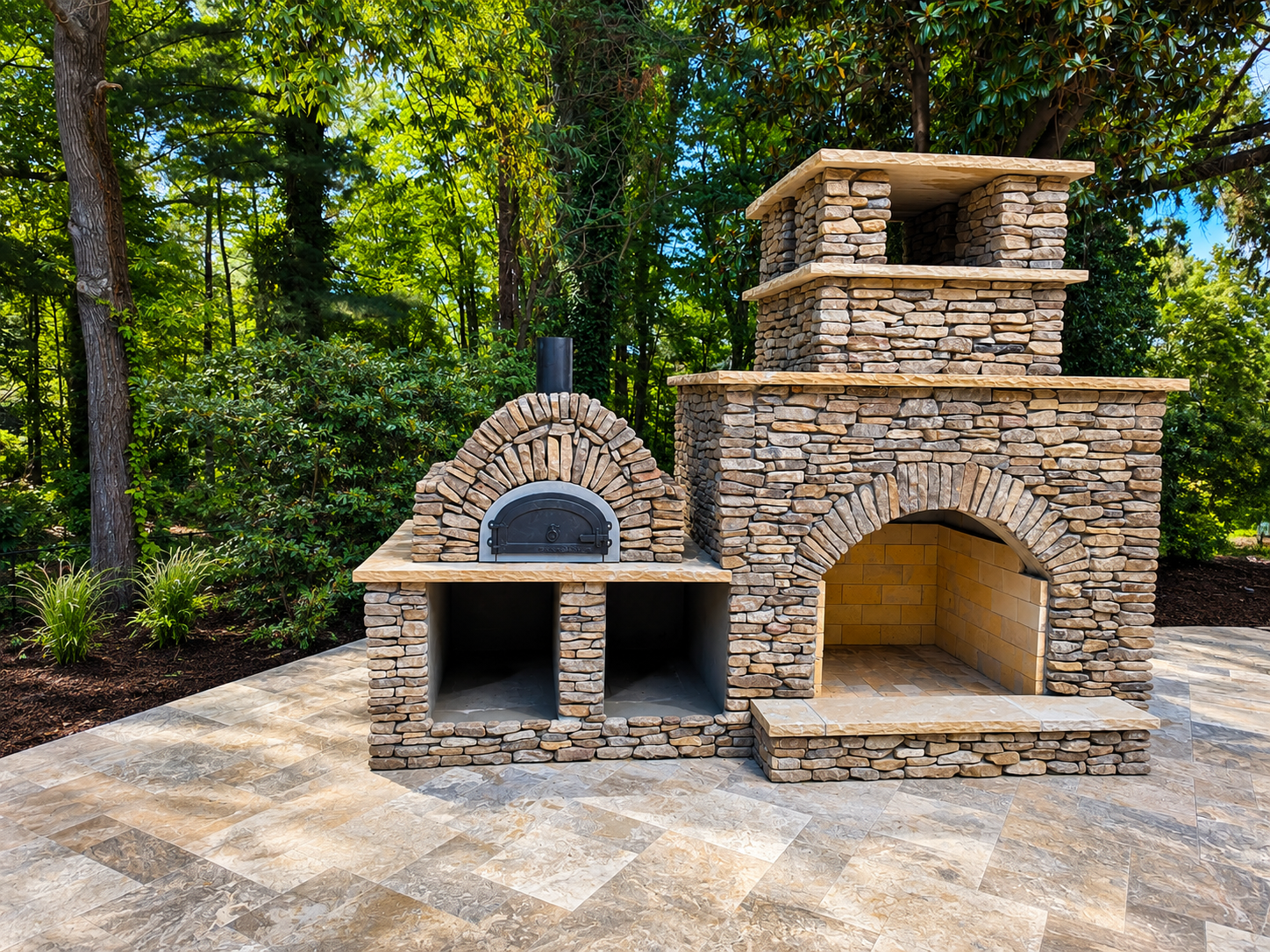 Custom stacked stone outdoor fireplace with built-in pizza oven on a stone patio